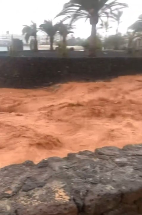 Floodwaters rushing through an island.
