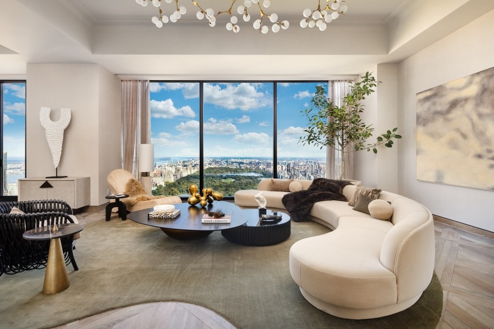 Living room with curved sofa and city view.