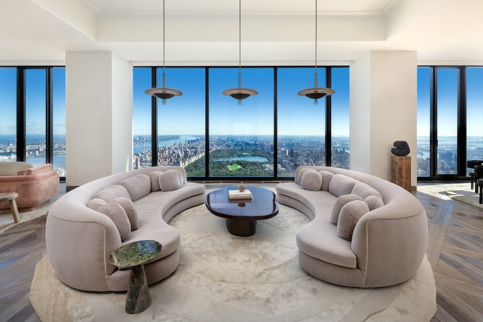Great room with curved sofa and city view.