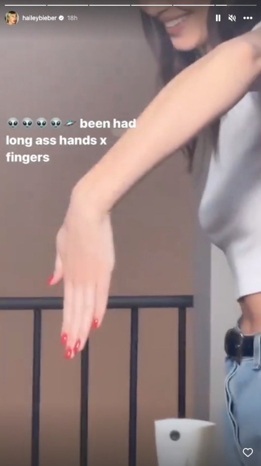 Video of a woman showing her hands in response to comments about their length.