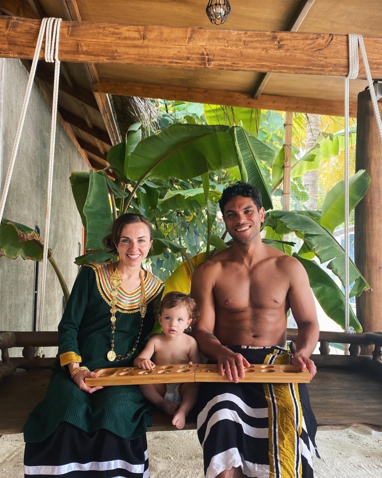 Family on vacation playing a board game.