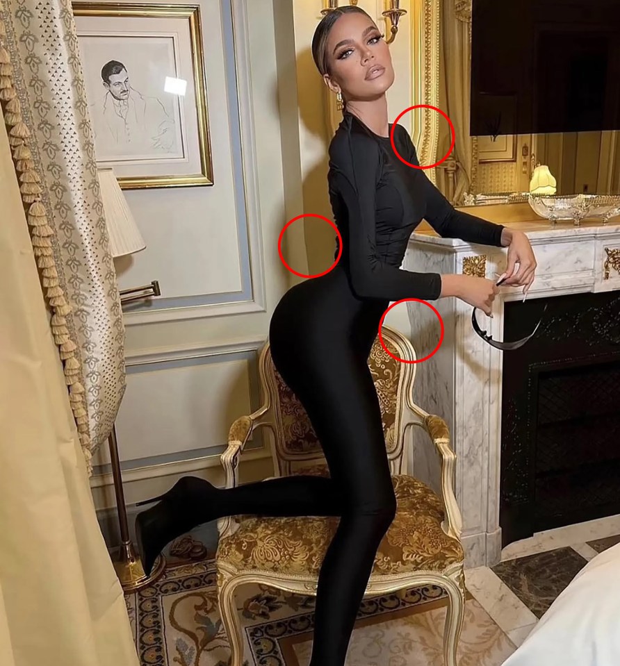 Khloe Kardashian in a black bodysuit, posing in a luxurious room.