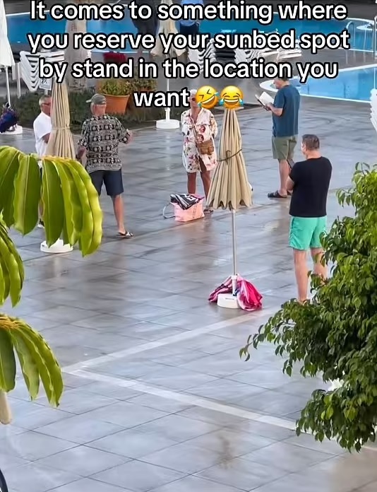 Tourists reserving sunbeds by standing in their desired location.