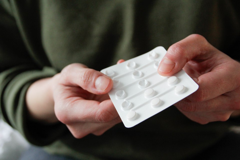 Person holding a blister pack of pills.