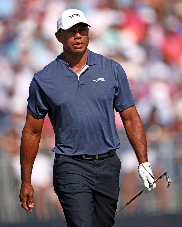 Tiger Woods walking on a golf course.