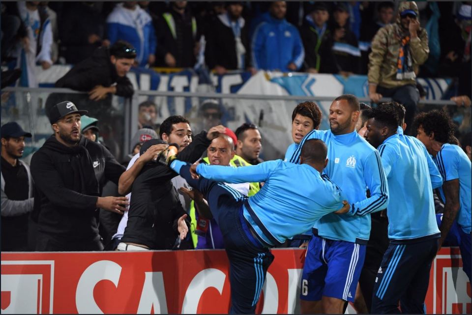 Patrice Evra kicking a fan during a soccer game.