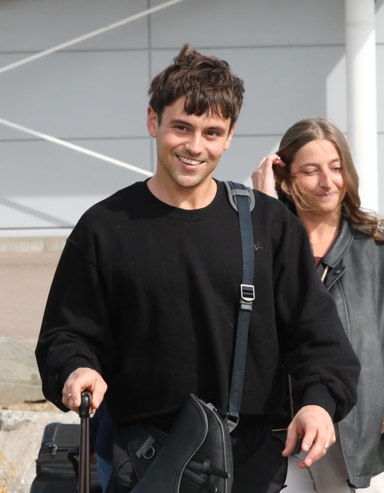 Tom Daley arriving at an airport.