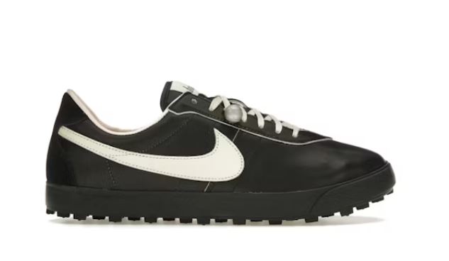 Black Nike trainer with off-white swoosh.