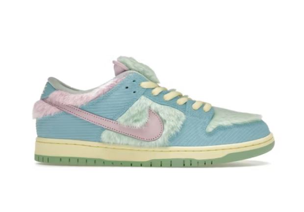 Nike Dunk Low trainers in light blue with pink and light green fur accents.