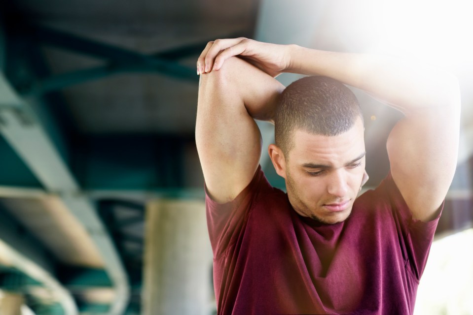 Man stretching his arm.
