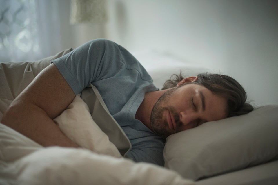 Man sleeping in bed.