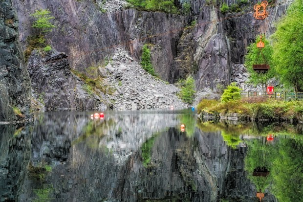 Reflection of a slate quarry in still water.