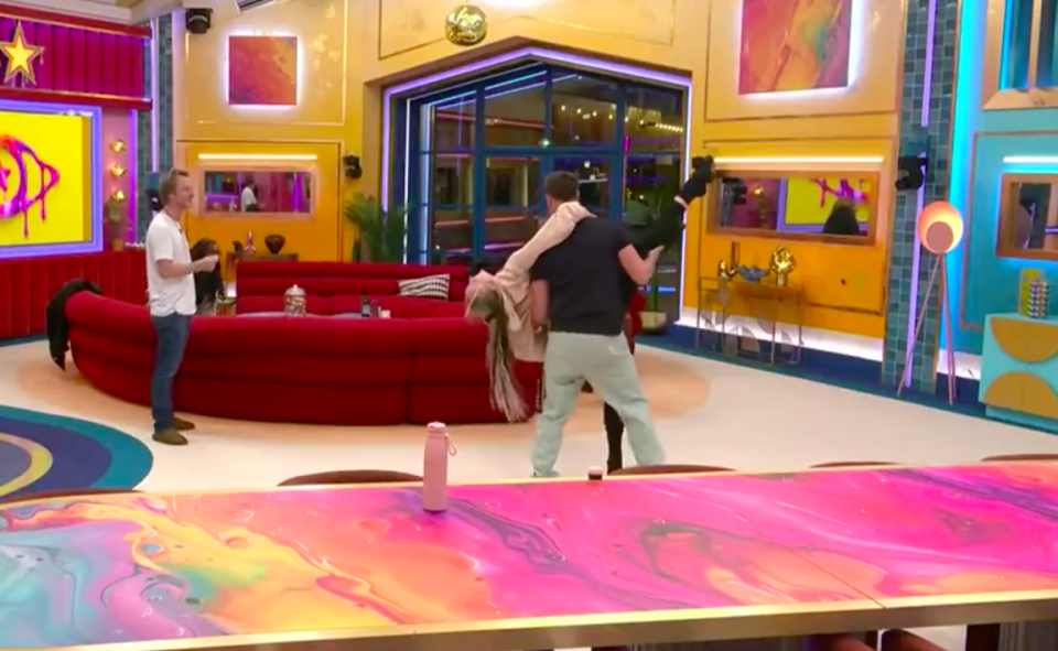 Celebrity Big Brother housemates embracing.
