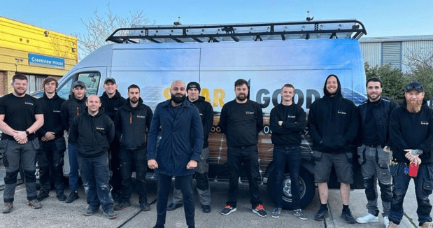 Team photo in front of a van.