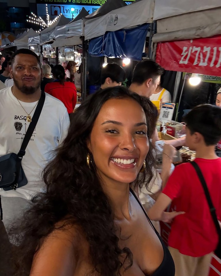 Woman smiling at a night market.