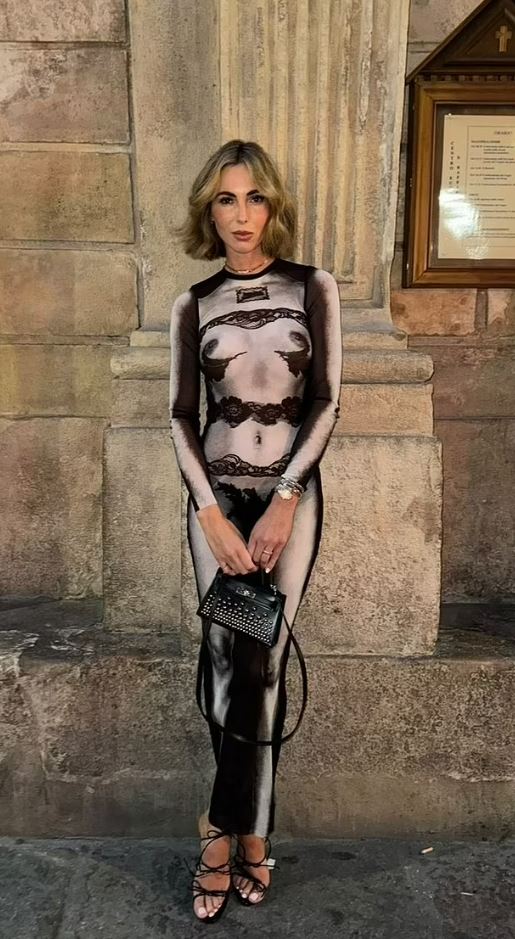 Woman in sheer lingerie-printed dress and black heels.