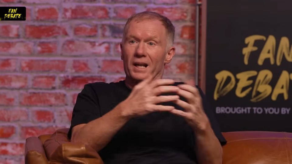 Paul Scholes holding a TNT Sports microphone during a UEFA Europa League match.
