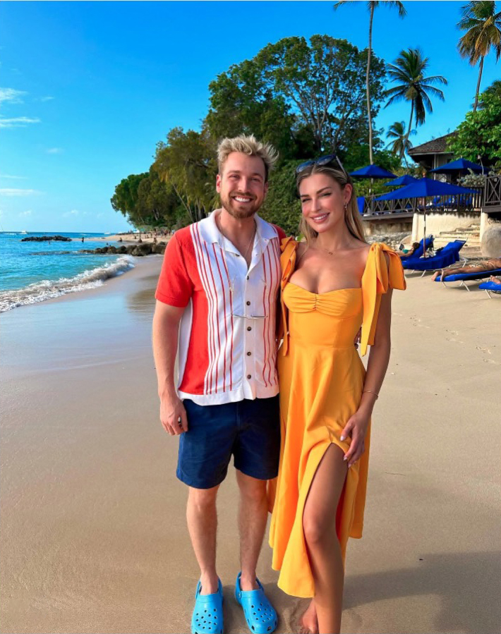 Zara McDermott and Sam Thompson on a beach.