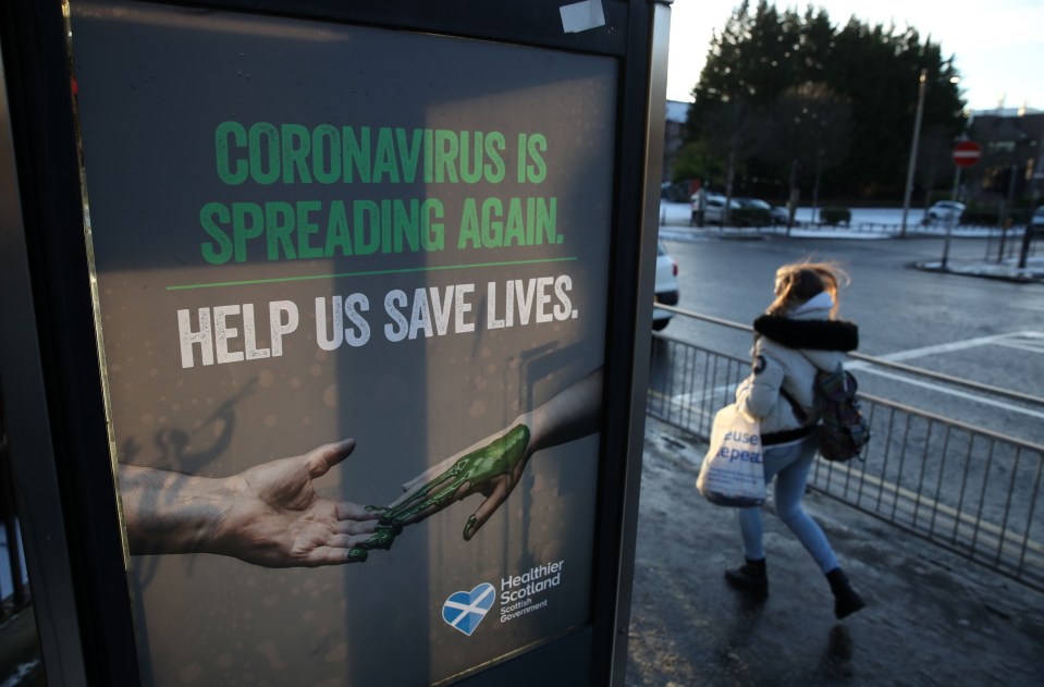 Poster on a phone box urging people to help save lives as coronavirus is spreading again.