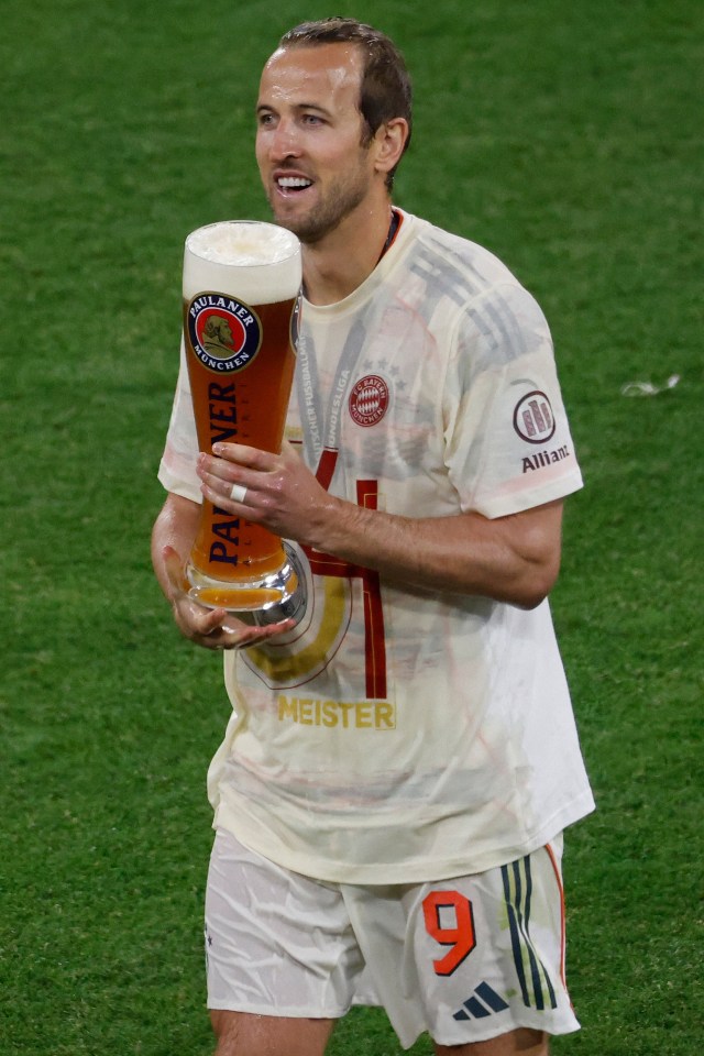 Harry Kane celebrating with a beer after a soccer game.