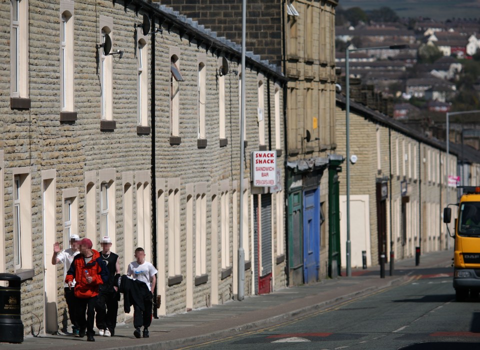 A group of boys walking down a street in Burnley, Lancashire.