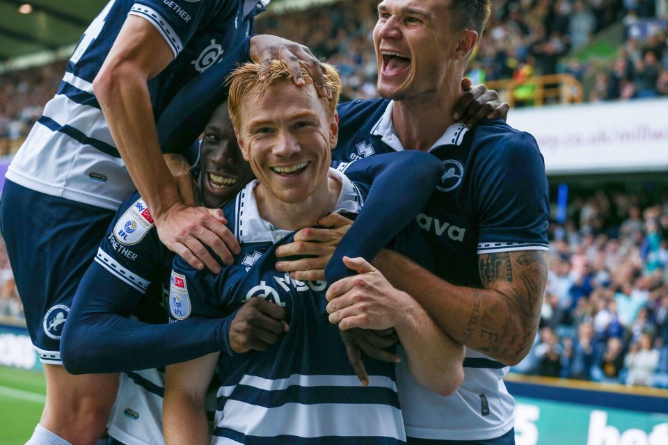 Soccer players celebrating a goal.