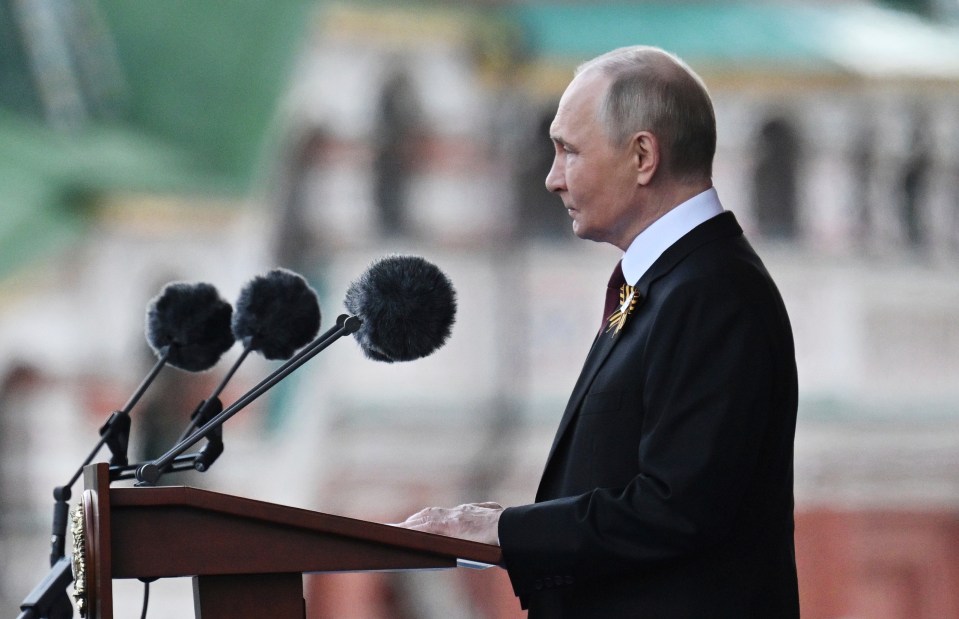 Vladimir Putin speaking at a podium.