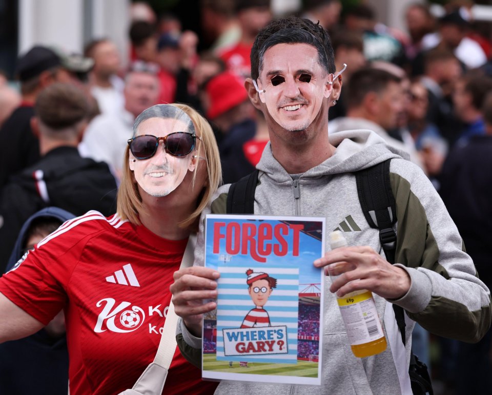 Nottingham Forest fans wearing Gary Neville masks at a football match.