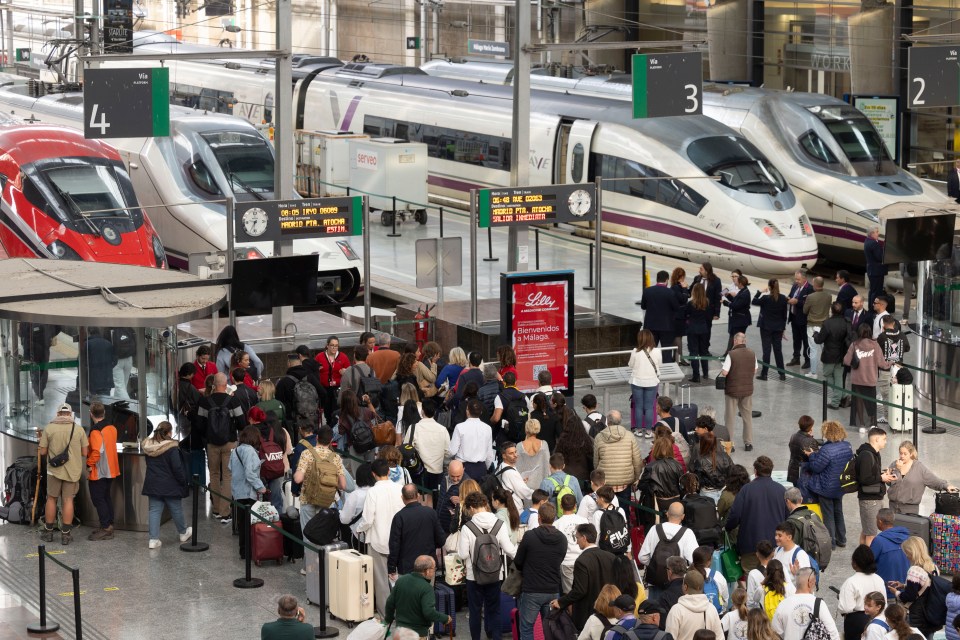 Passengers waiting at a train station in Malaga, Spain.
