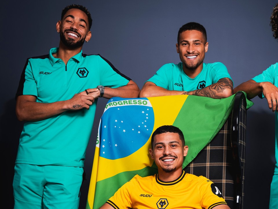 Four Wolverhampton Wanderers soccer players, including new signing Andre, pose for a photo.