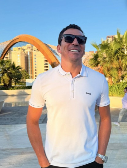 Man in sunglasses and a white Boss polo shirt.