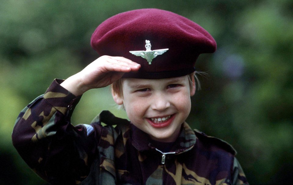 Prince William at age four saluting in a military uniform.