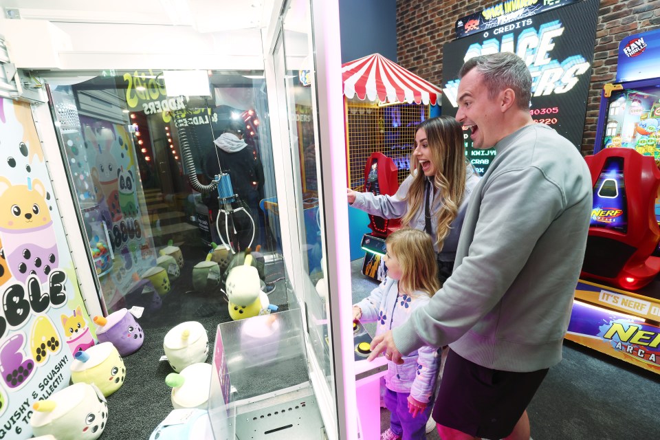 Family playing arcade games.