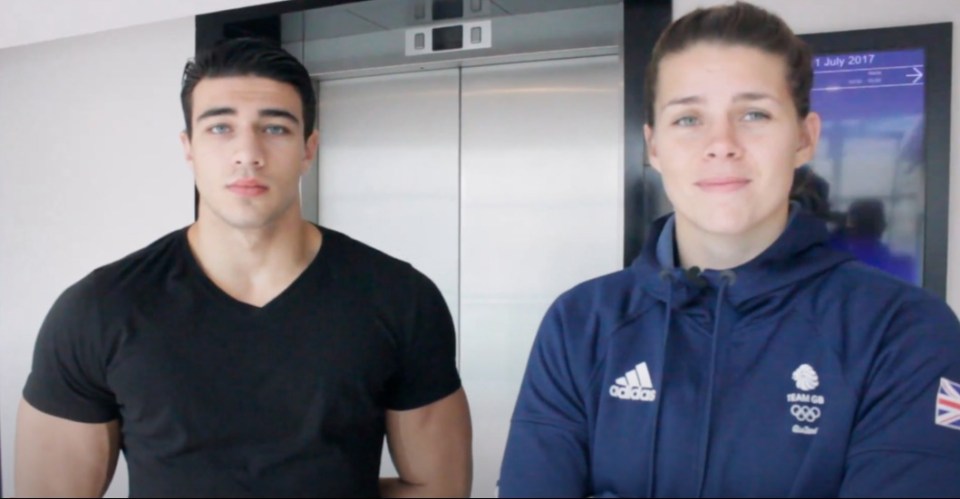 Screenshot of a man and woman standing in front of an elevator.