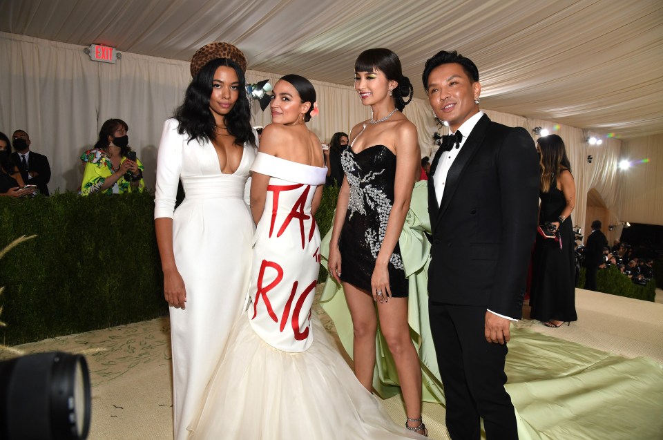 Alexandria Ocasio-Cortez at the Met Gala in a white dress with "Tax the Rich" written on it.