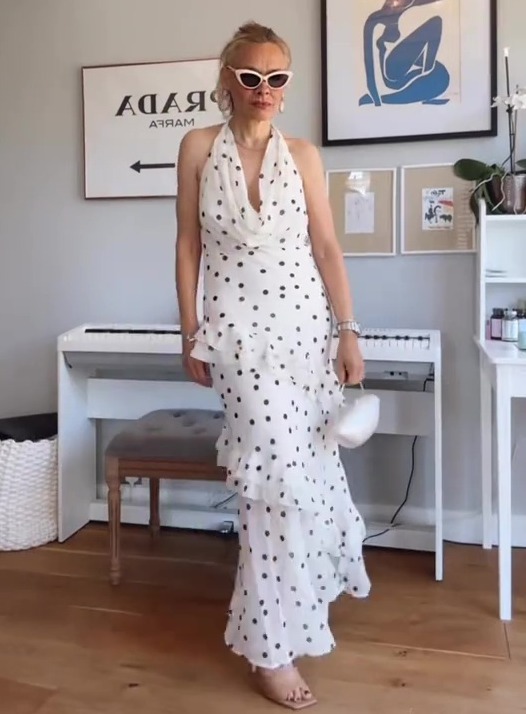 Woman in a white polka dot dress.