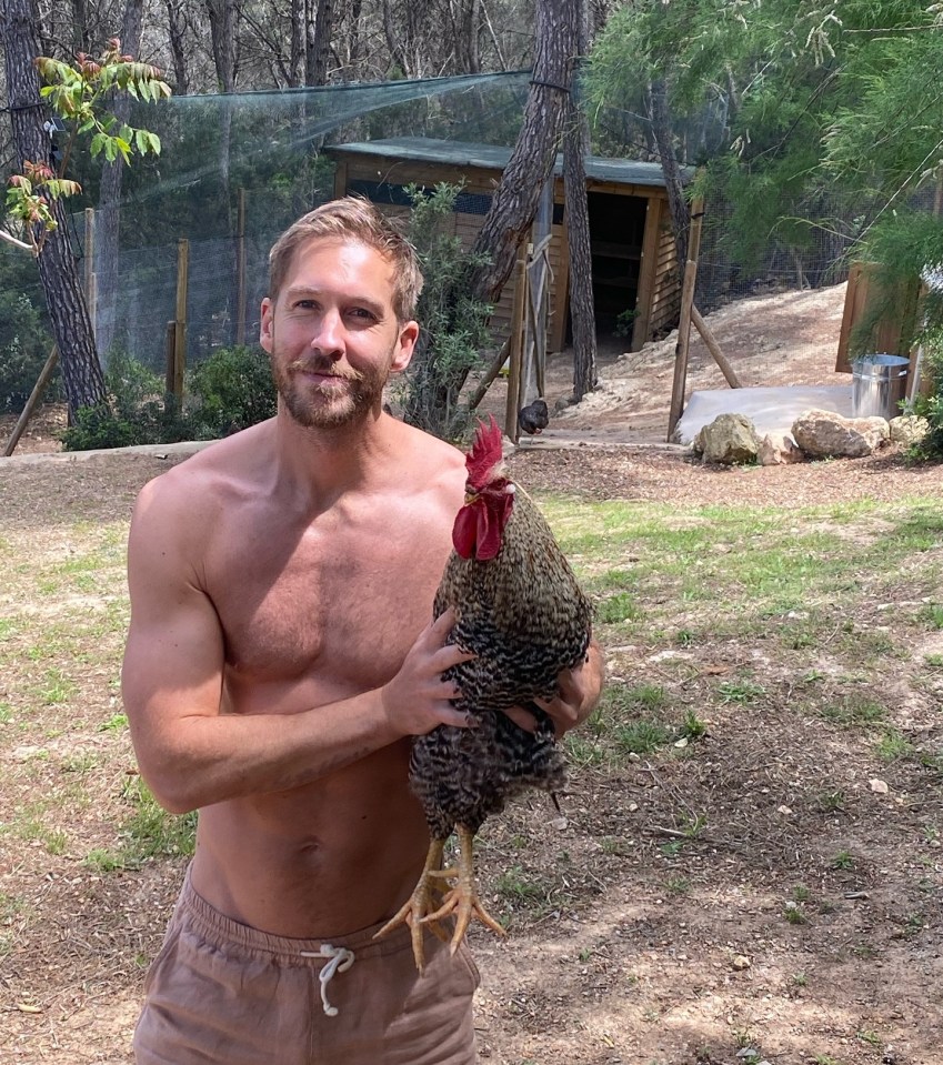Shirtless man holding a rooster.