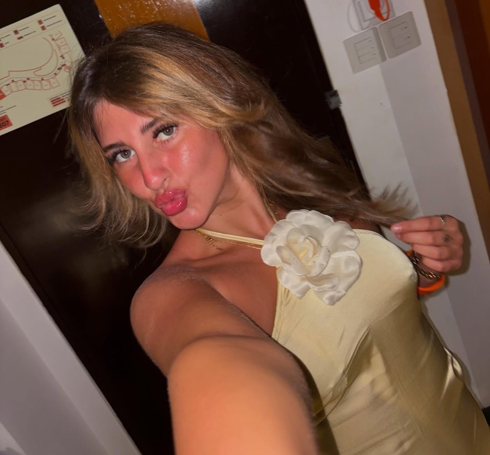 Selfie of a woman in a pale yellow dress.