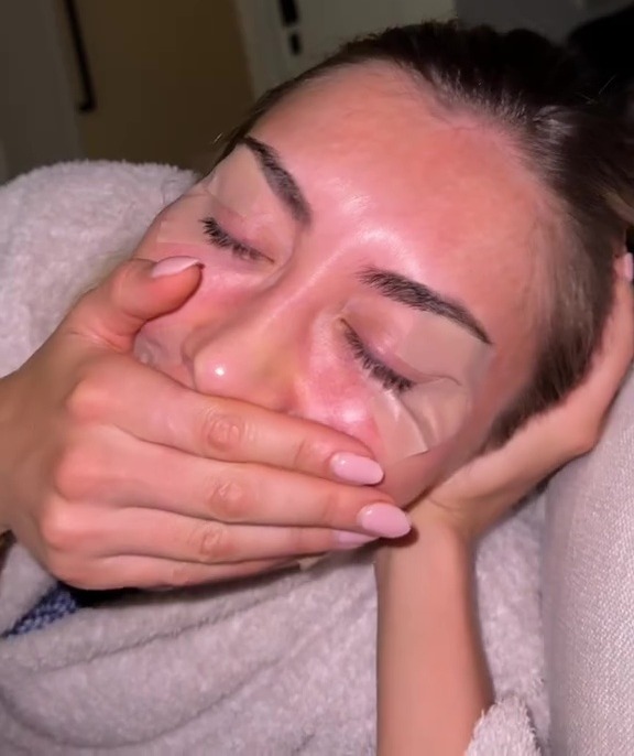 Woman with under-eye patches covering her eyes.
