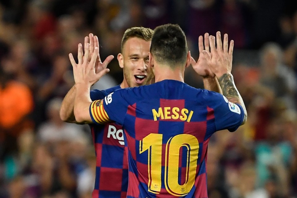 Barcelona's Brazilian midfielder Arthur is congratulated by teammate Barcelona's Argentine forward Lionel Messi after scoring the second goal during the Spanish league football match between FC Barcelona and Villarreal CF at the Camp Nou stadium in Barcelona, on September 24, 2019. (Photo by LLUIS GENE / AFP)        (Photo credit should read LLUIS GENE/AFP via Getty Images)