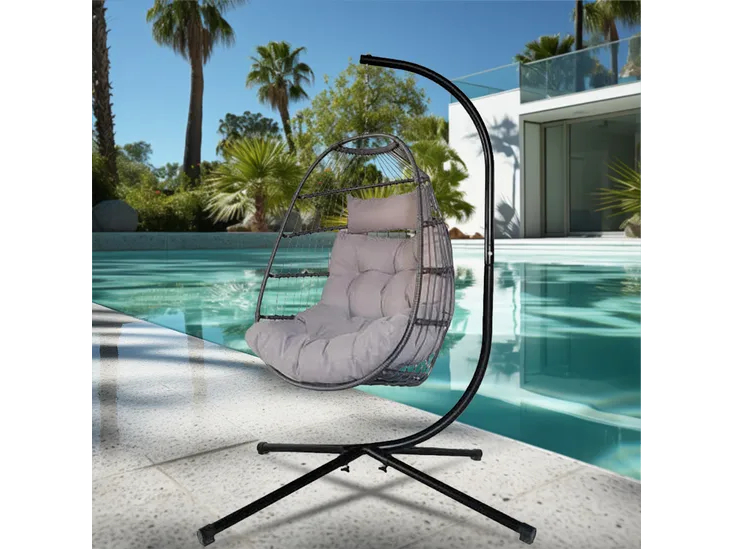 Hanging egg chair with gray cushion and black stand by the pool.