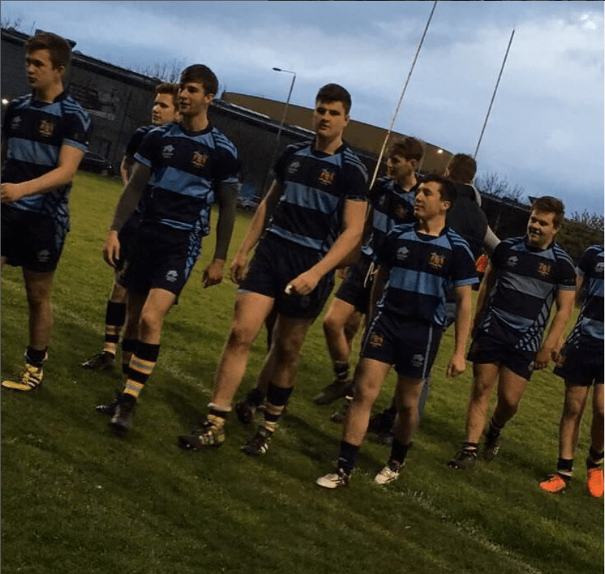 Rugby team walking on a field.