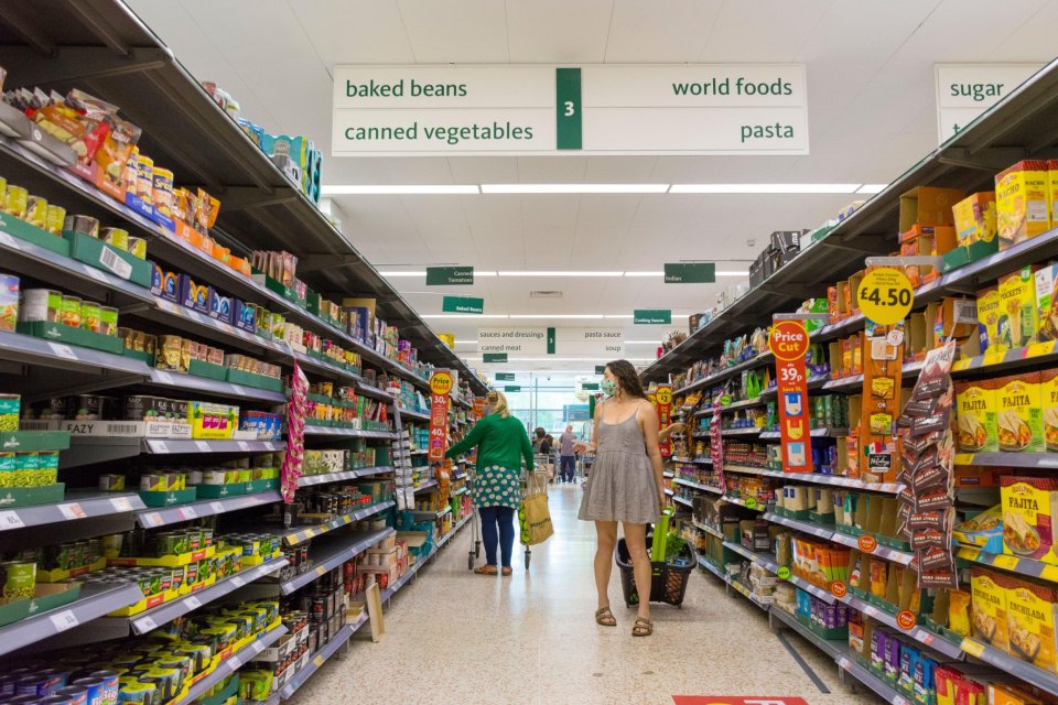 Shoppers in a Morrisons supermarket aisle.