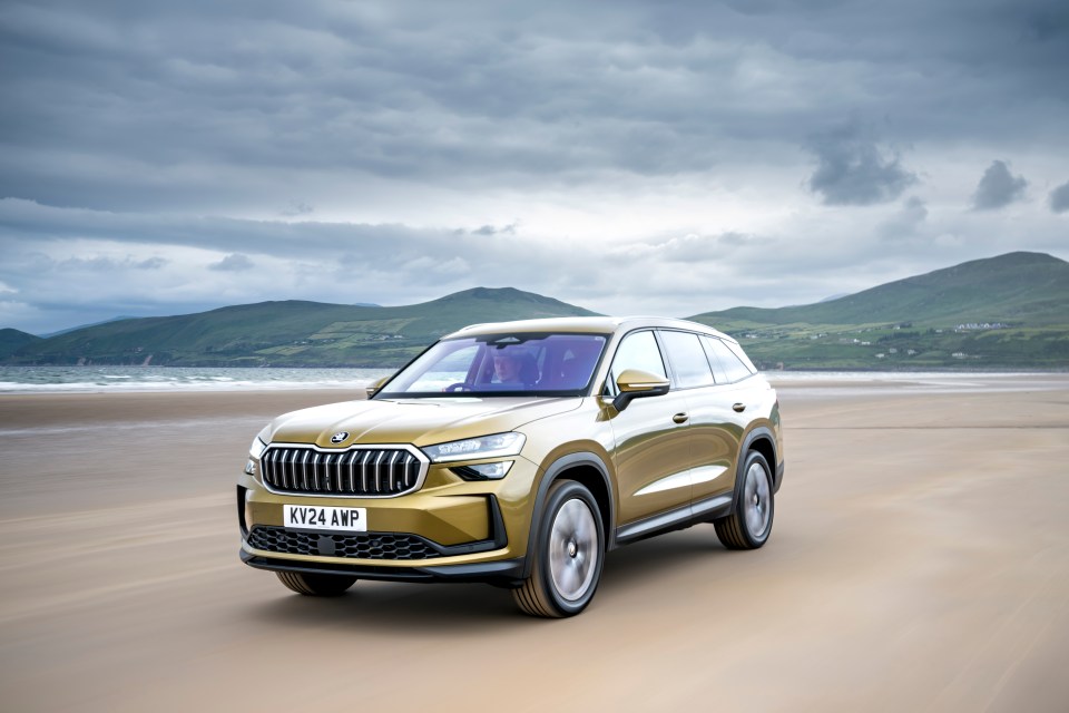 Gold SUV driving on a beach.