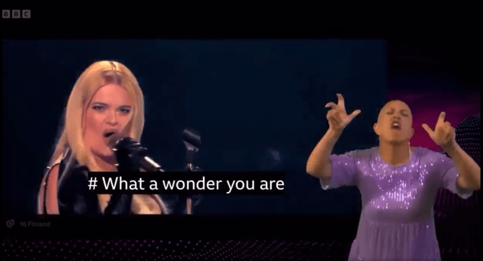Singer performing "What a wonder you are" with sign language interpreter.
