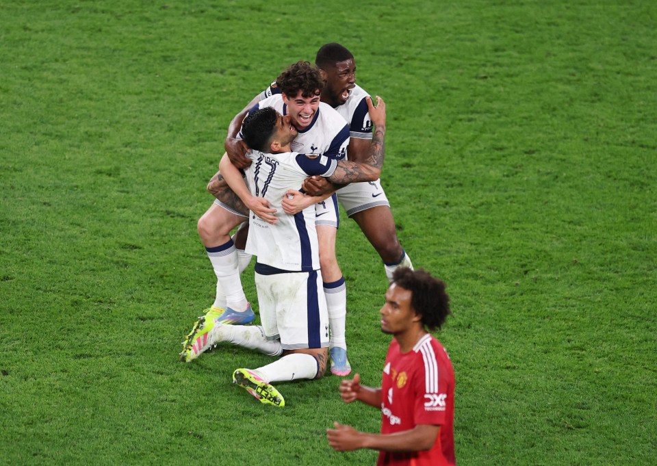 Soccer Football - Europa League - Final - Tottenham Hotspur v Manchester United - San Mames, Bilbao, Spain - May 21, 2025 Tottenham Hotspur's Kevin Danso, Cristian Romero and Archie Gray celebrate winning the Europa League as Manchester United's Joshua Zirkzee looks dejected REUTERS/Juan Medina