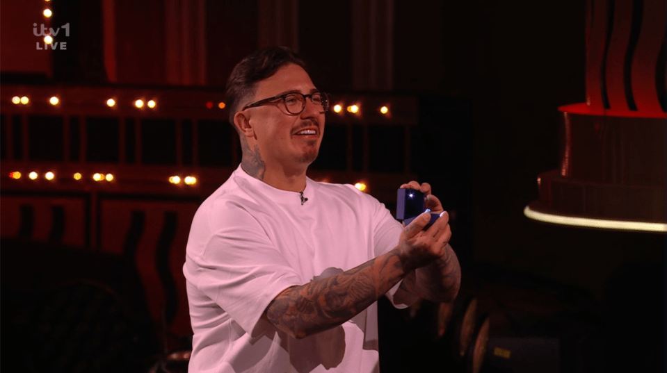 Man holding a small blue ring box.