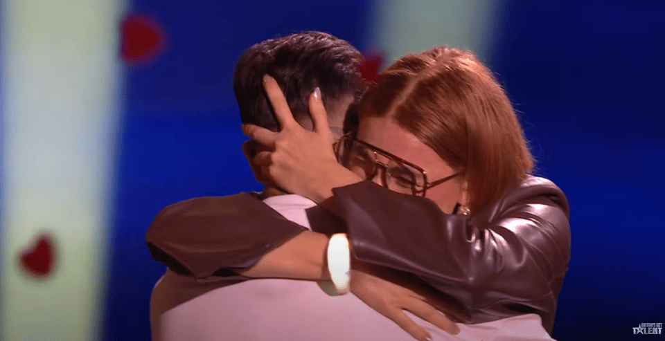 Screenshot of a woman hugging a man.