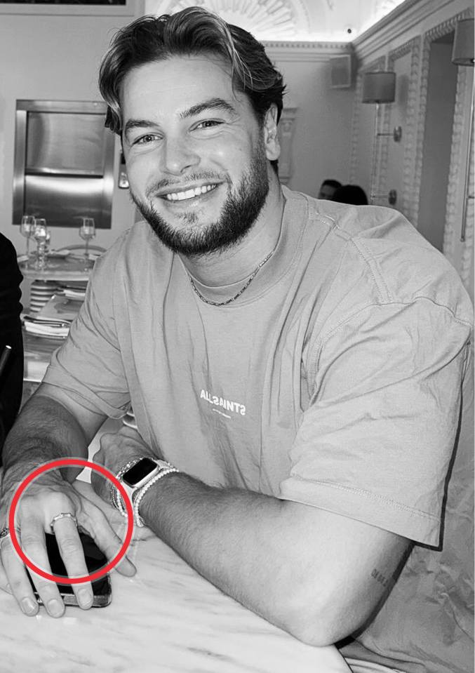 Black and white photo of Chris wearing a ring.