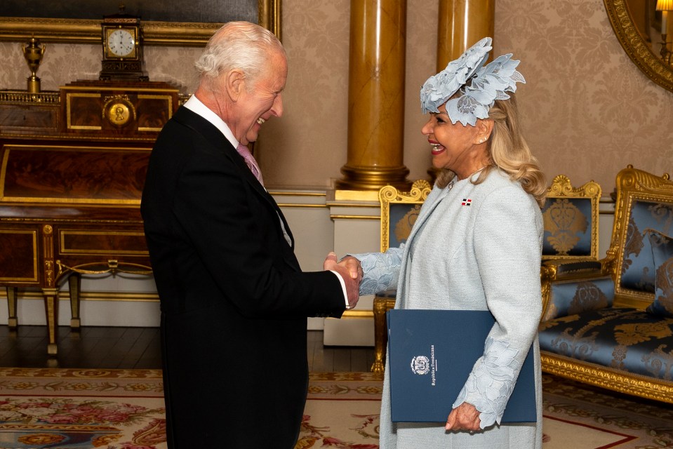 King Charles III shaking hands with the Ambassador of the Dominican Republic at Buckingham Palace.